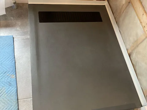 Concrete shower base, linea model, polished charcoal color.